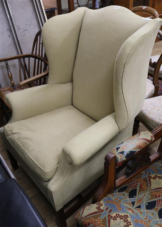 An upholstered wingback armchair